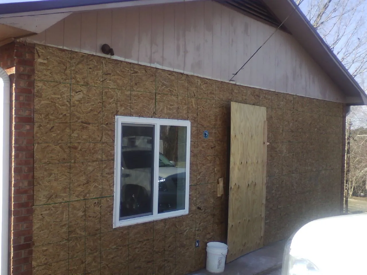 OSB sheathing on a garage addition wall before siding in Lancaster